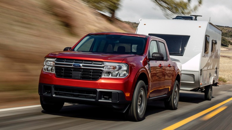 Red 2024 Ford Maverick towing RV