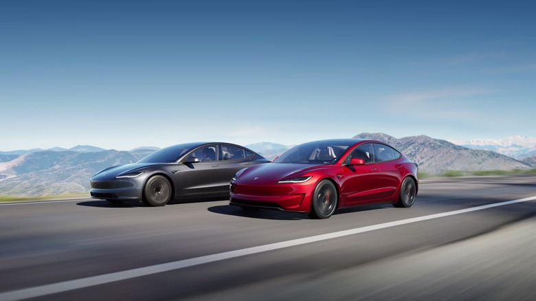 Two Tesla Model 3 cars driving side by side