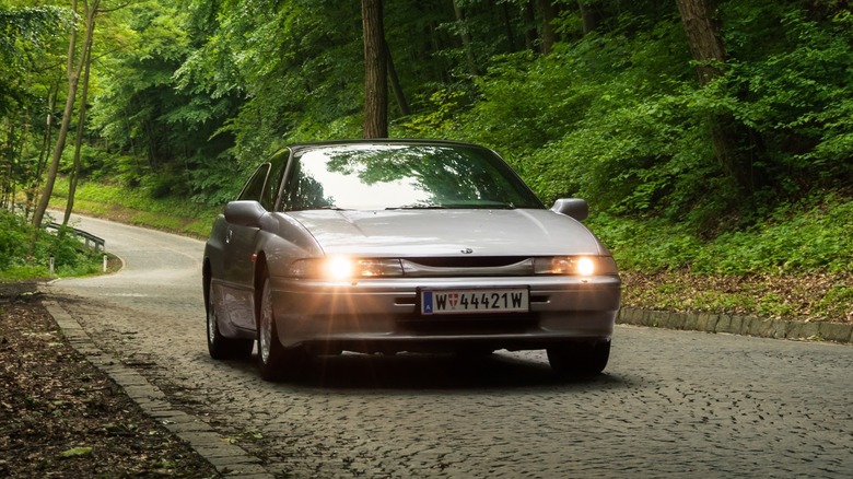 Silver Subaru SVX on road