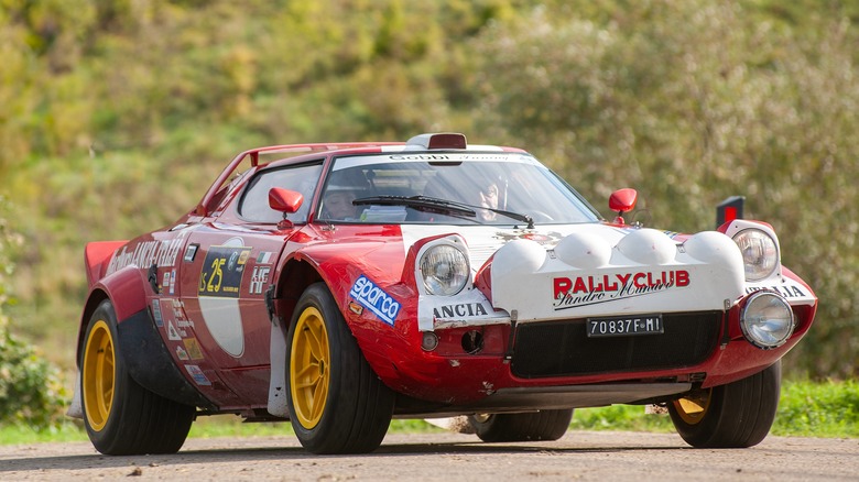 A Lancia Stratos on a rally stage, front 3/4 view