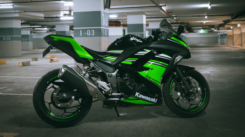 A Kawasaki Ninja motorcycle parked in a parking structure