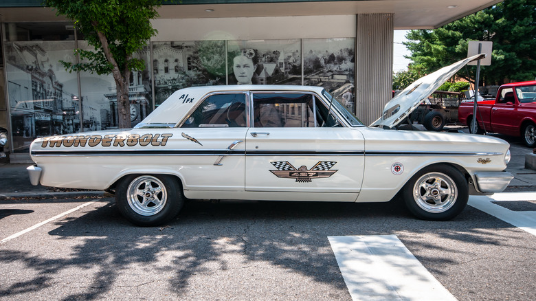 A Ford Fairlane Thunderbolt parked on a city street