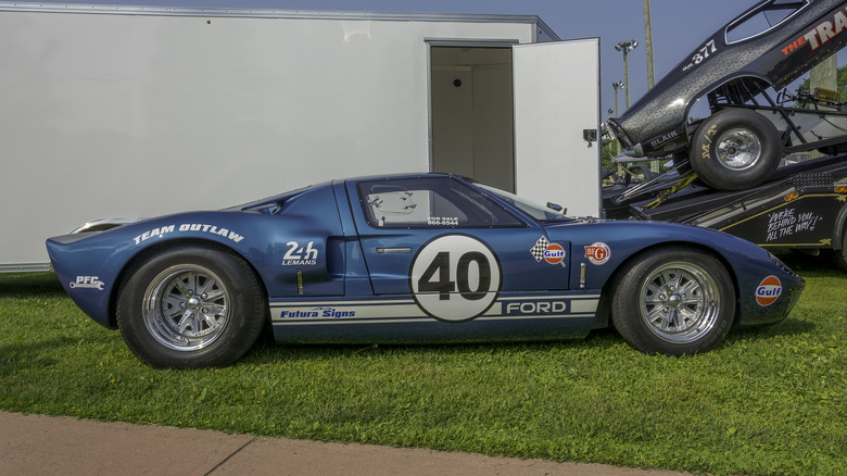 A blue Ford GT40 parked in the grass