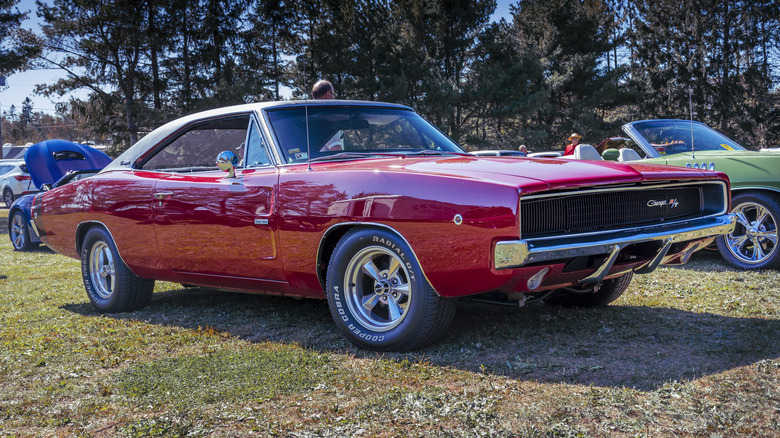 A red Dodge Charger at a car show