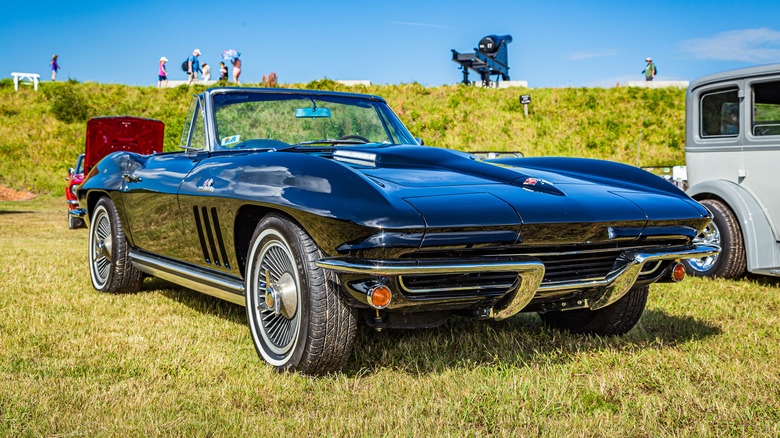 A Chevy Corvette parked in the grass at an event