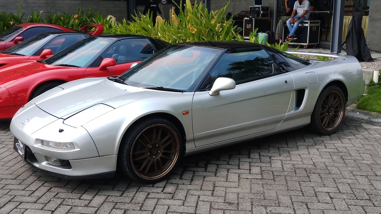 A silver Honda NSX in a parking lot