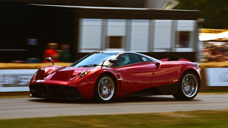 A red Pagani Huayra driving on a track