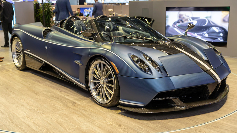 A blue Pagani Huayra on a showroom floor