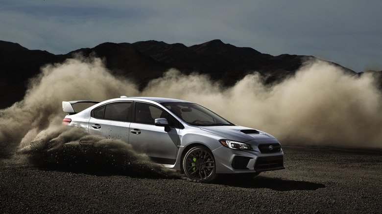 2020 Subaru WRX STI drifting on a sandy surface front 3/4 view