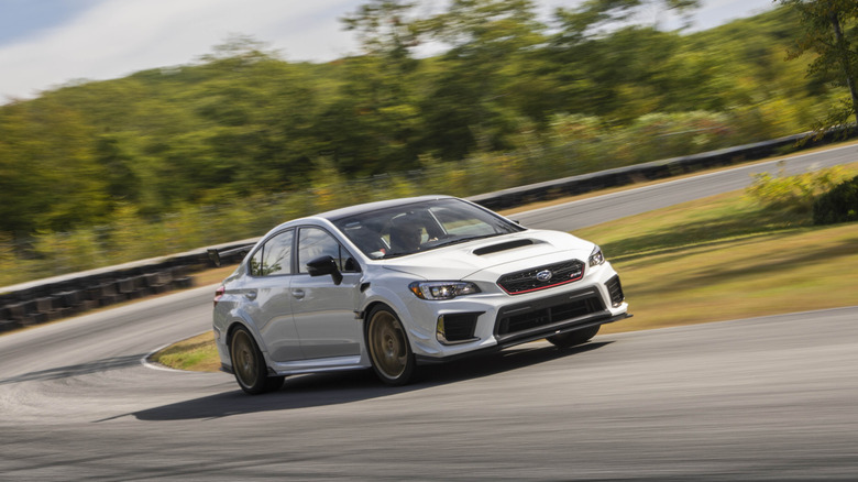 2019 Subaru STi S209 driving fast on track front 3/4 view