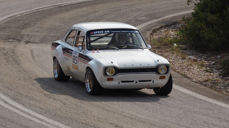 Ford Escort RS1600 on asphalt racetrack cornering at speed