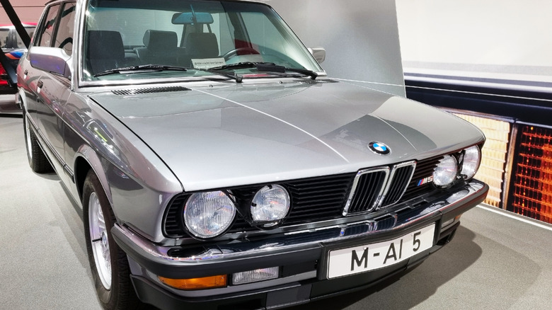 A BMW E28 M5 in a showroom