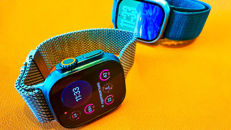 An Apple Watch Ultra with a Milaense Loop and another one with a trail loop on a yellow background