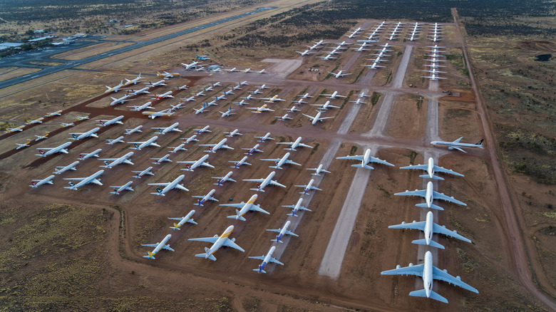 Small and large aircraft parked in many rows