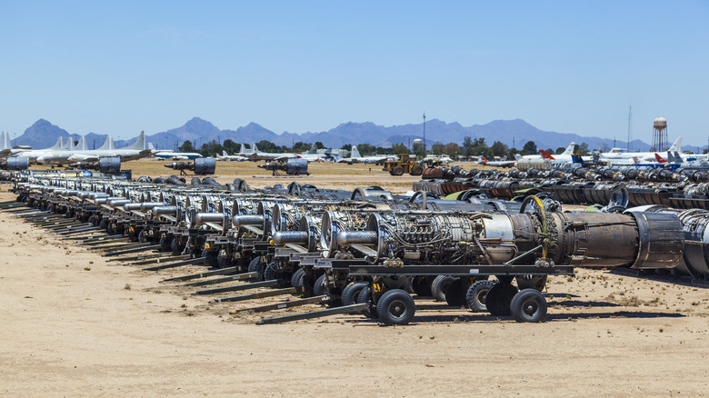 Airplane parts dismantled for recycling with a few planes in background