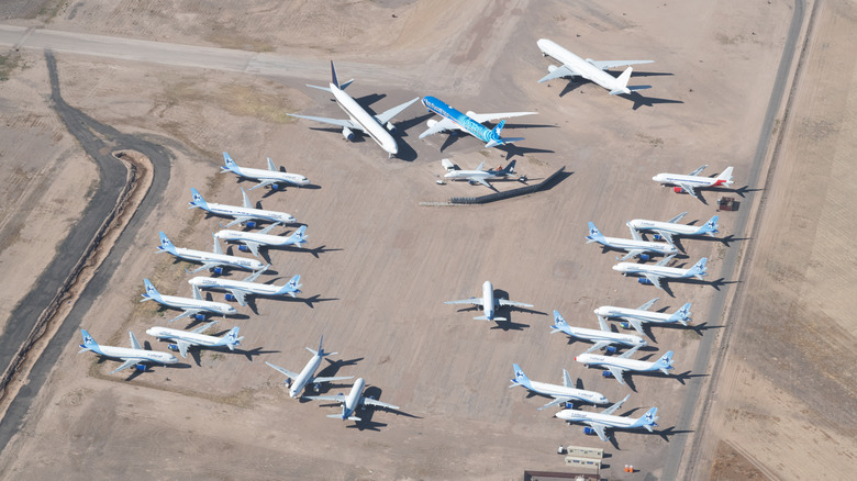 Several airplanes stored in desert with empty area in the surrounding