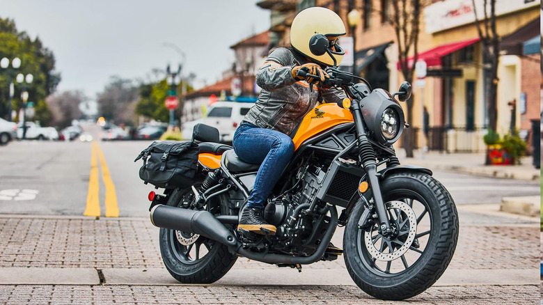 Person riding a yellow Honda Rebel 300