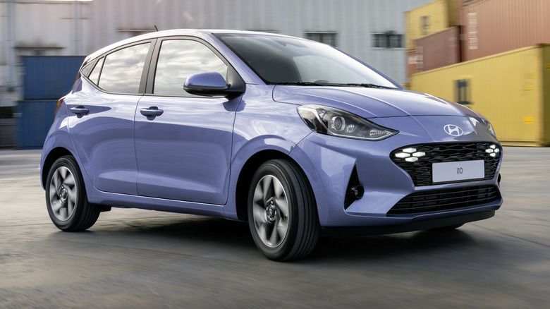 Light blue Hyundai i10 parked near shipping containers