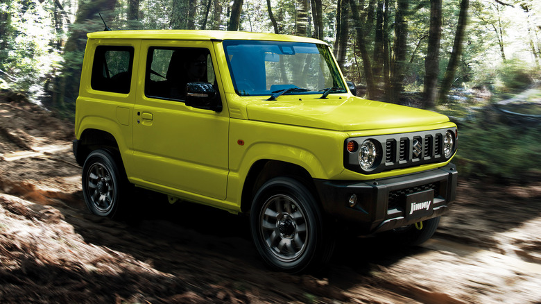 Yellow Suzuki Jimny minicar in a wooded area