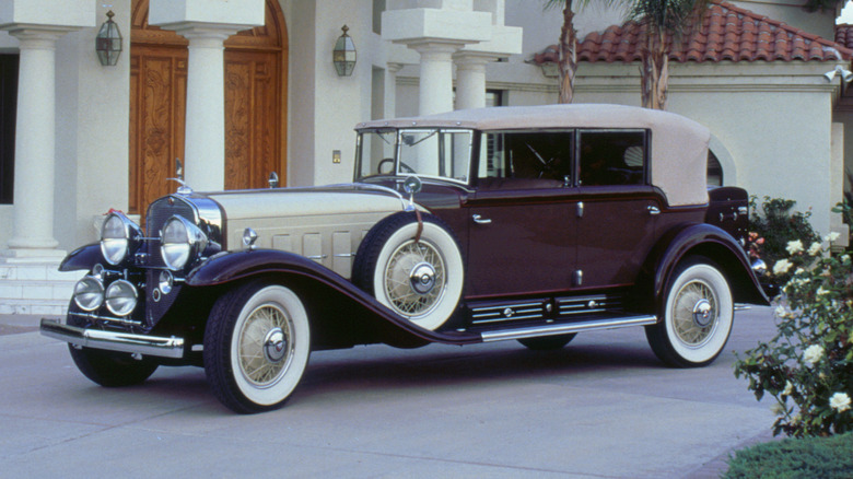 Cadillac V16 on mansion driveway