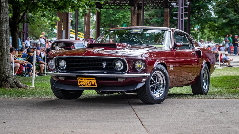 A red 1969 Ford Mustang Boss 429 at a car show