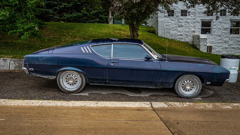 A 1969 Ford Torino Talladega parked on a village street