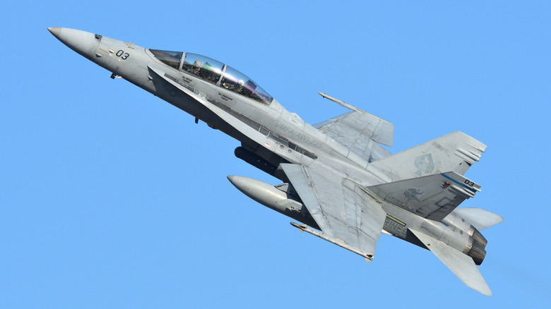 F/A-18 aircraft climbing in a left turn