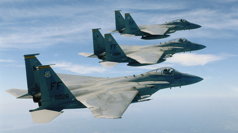 Three fighter jets flying in formation in the sky