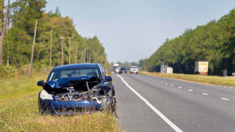 Crashed car next to highway