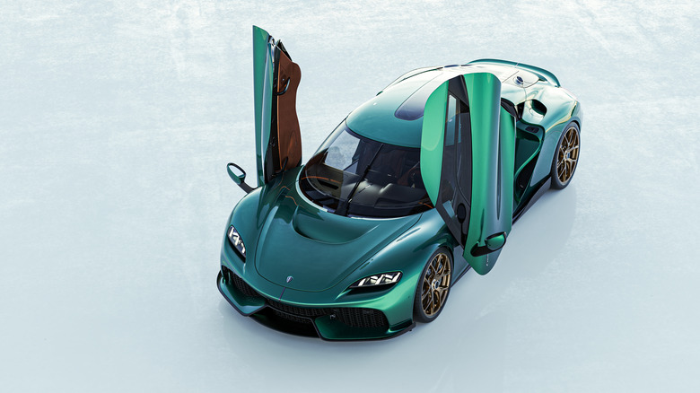 The production Koenigsegg Gemera in green, front 3/4 view, doors up