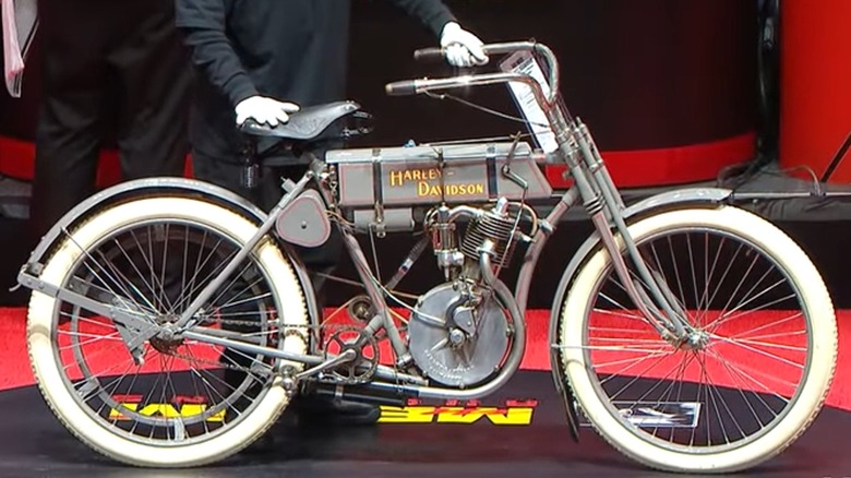 A 1908 Harley-Davidson Strap Tank parked in a museum