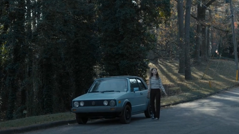 Nancy Wheeler standing in front of Barbara Holland's 1988 Volkswagen Cabriolet from Stranger Things