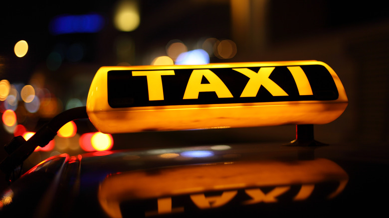 A yellow cab taxi sign