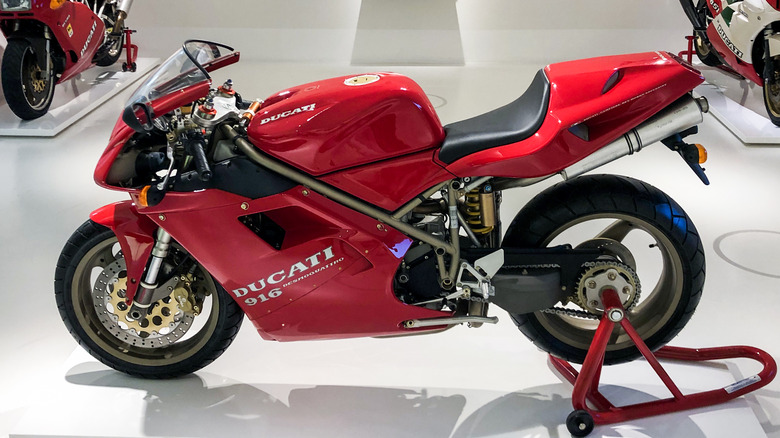 red Ducati 916 motorcycle parked on display