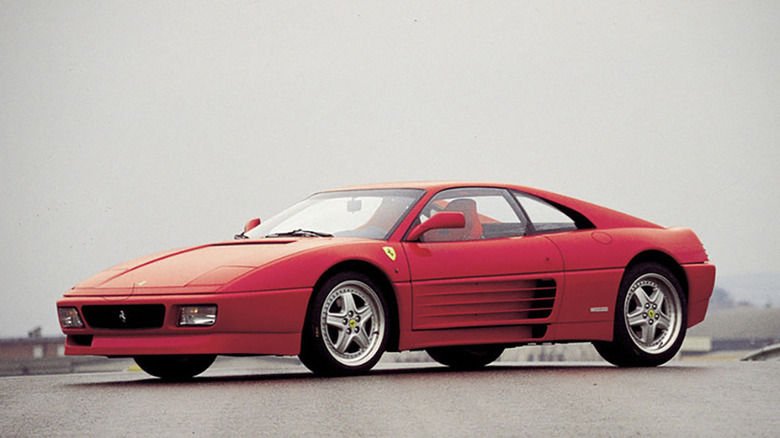 Red Ferrari 348 GT Competizione parked on a road front 3/4 view