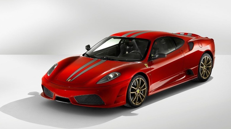 Red Ferrari 430 Scuderia with two grey stripes front view 3/4