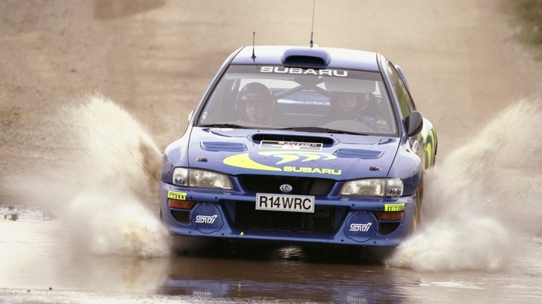 Colin McRae drives a Subaru Impreza WRX through floodwater