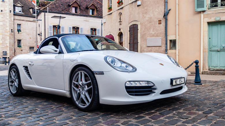 A white 987 Porsche Boxster, front 3/4 view