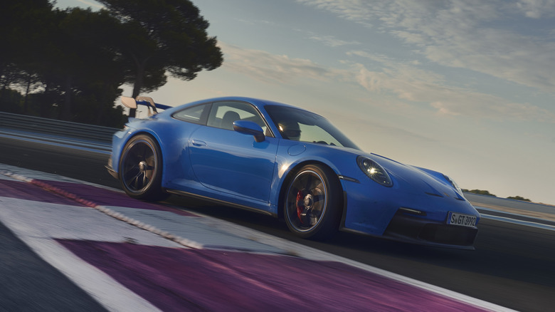 The 992 Porsche 911 GT3 at the track, blue exterior, front 3/4 view