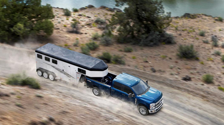 A blue Ford F-450 pulling an RV