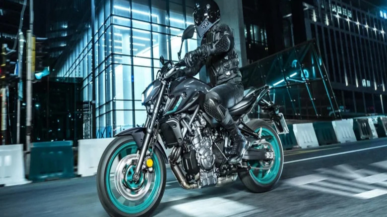 A man riding a black Yamaha MT-07 motorcycle