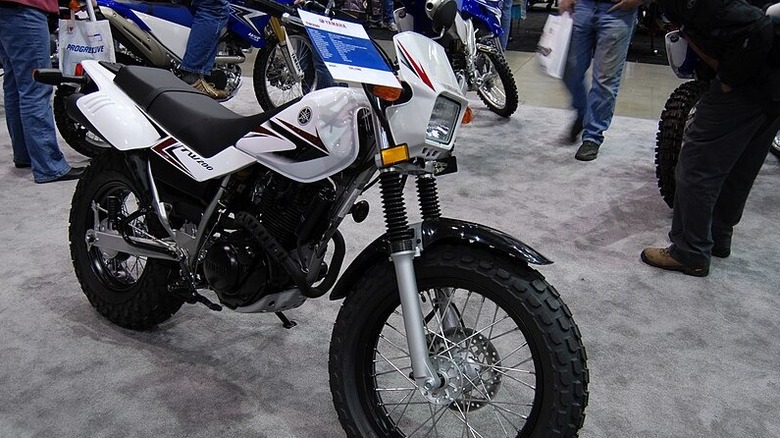 A Yamaha TW200 motorcycle parked at a show