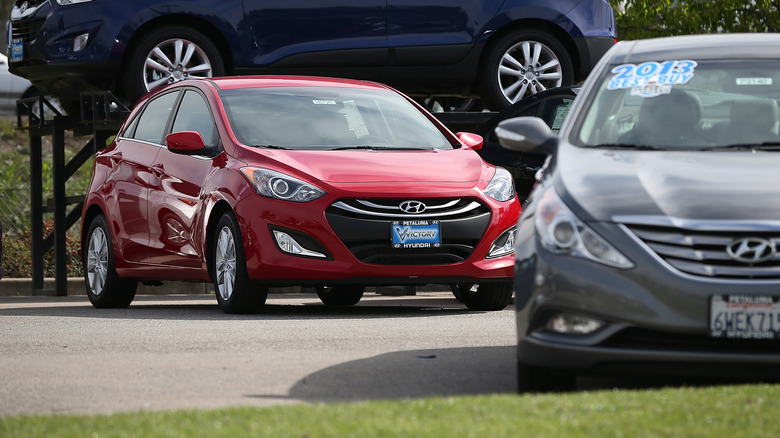 A red Hyundai Elantra from the early 2010s. 