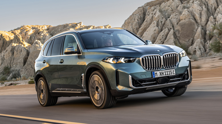 Green 2023 BMW X5 on the road