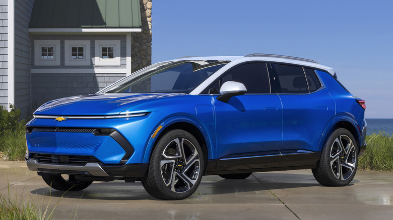 Blue 2024 Chevrolet Equinox EV parked on wet concrete