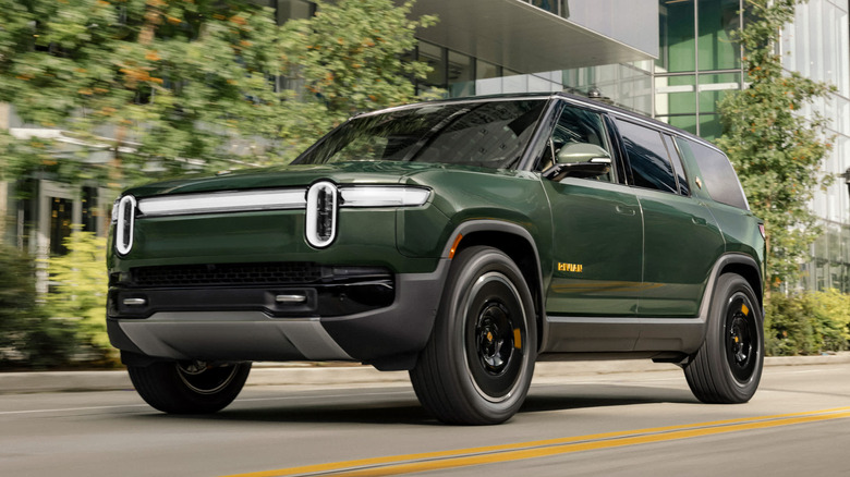 Dark green Rivian R1S on the road