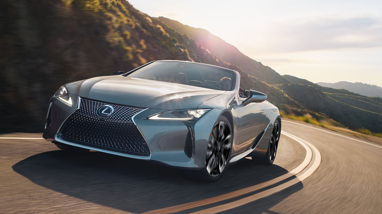 2025 Lexus LC 500 Convertible cornering at speed on an open road front 3/4 view