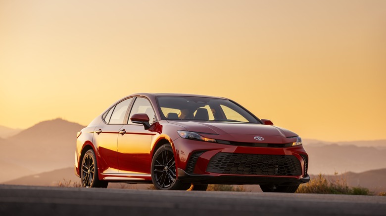 Red 2025 Toyota Camry front 3/4 view during sunset