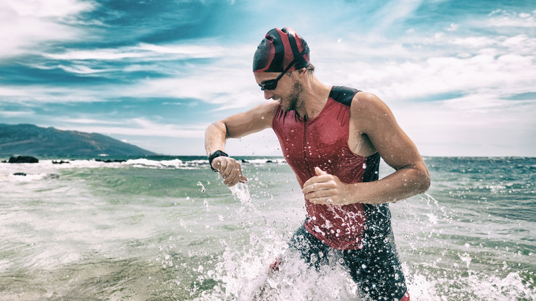 Man swimming with Fitbit tracker