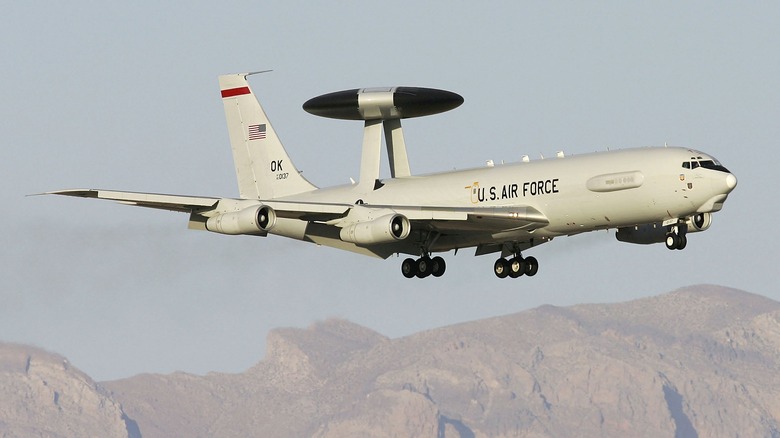 E-3 Sentry flying above Las Vegas mountains